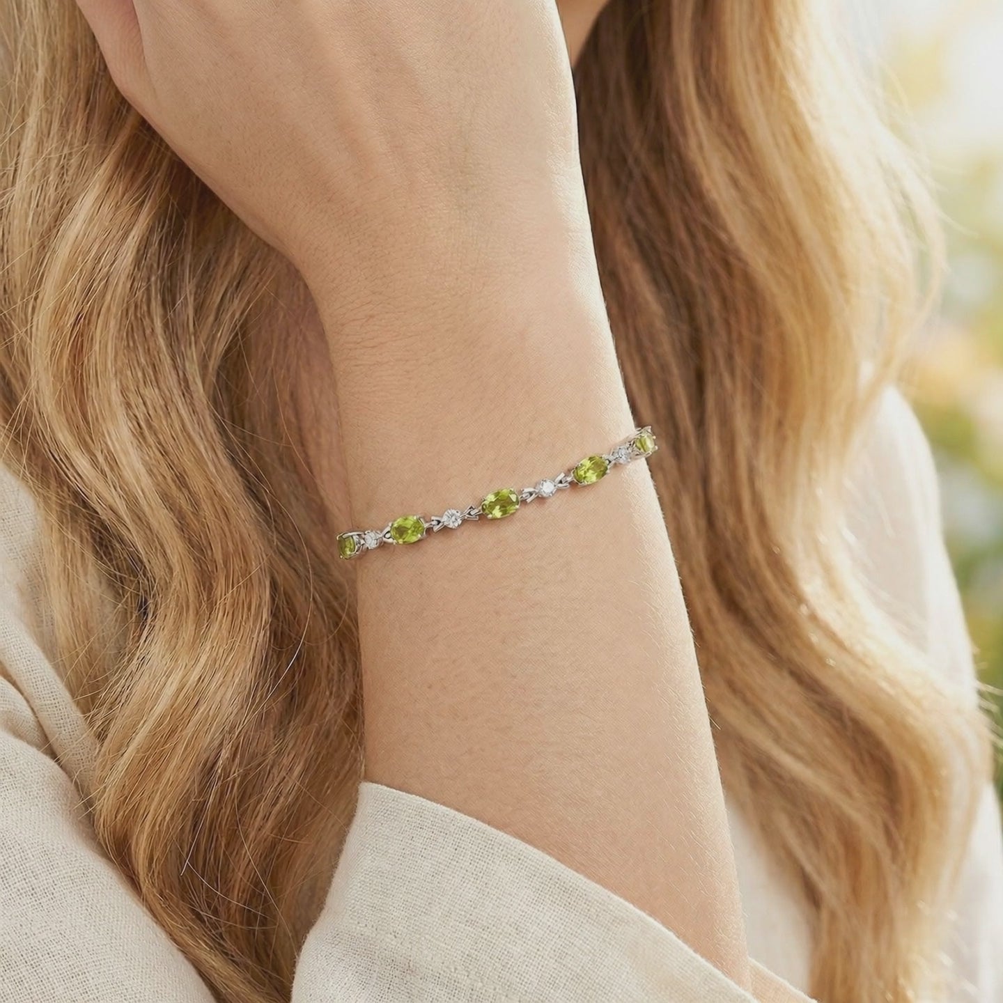 Video of an oval simulated peridot tennis bracelet in solid gold.