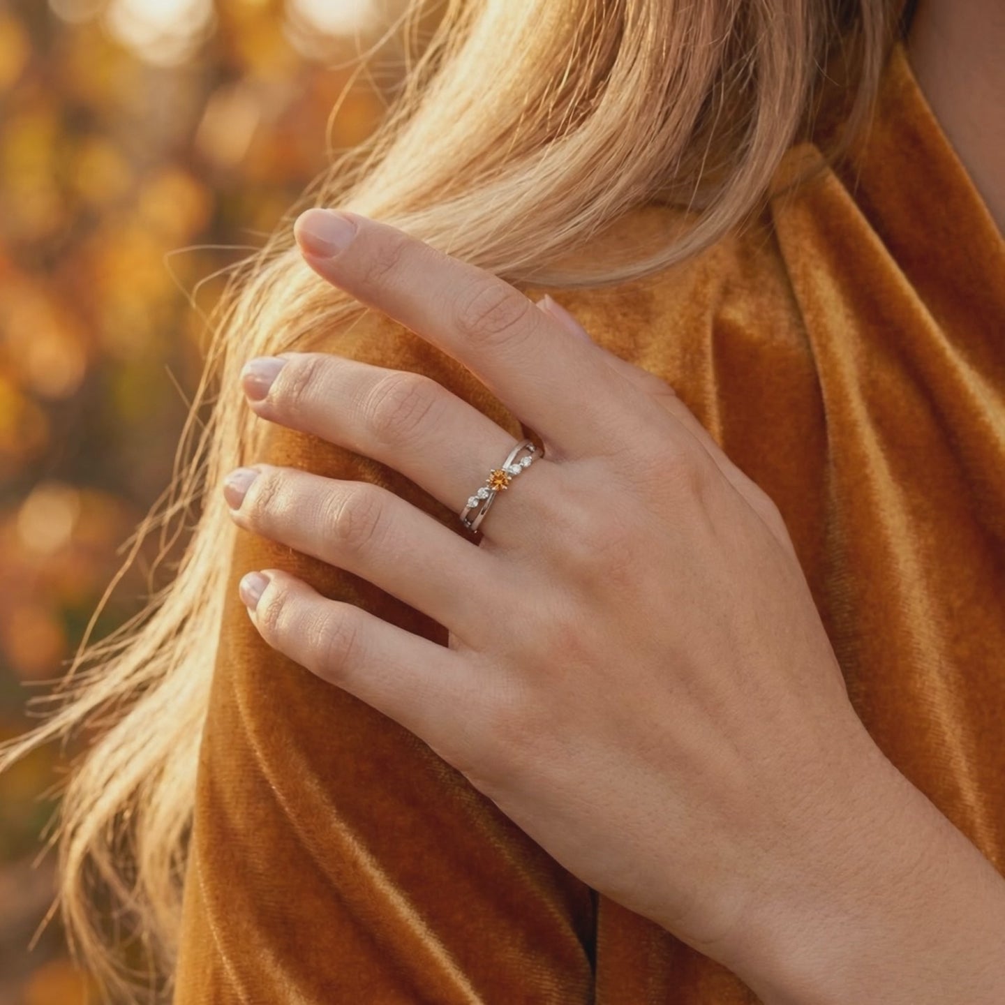 Solid gold crossover ring featuring a simulated topaz.