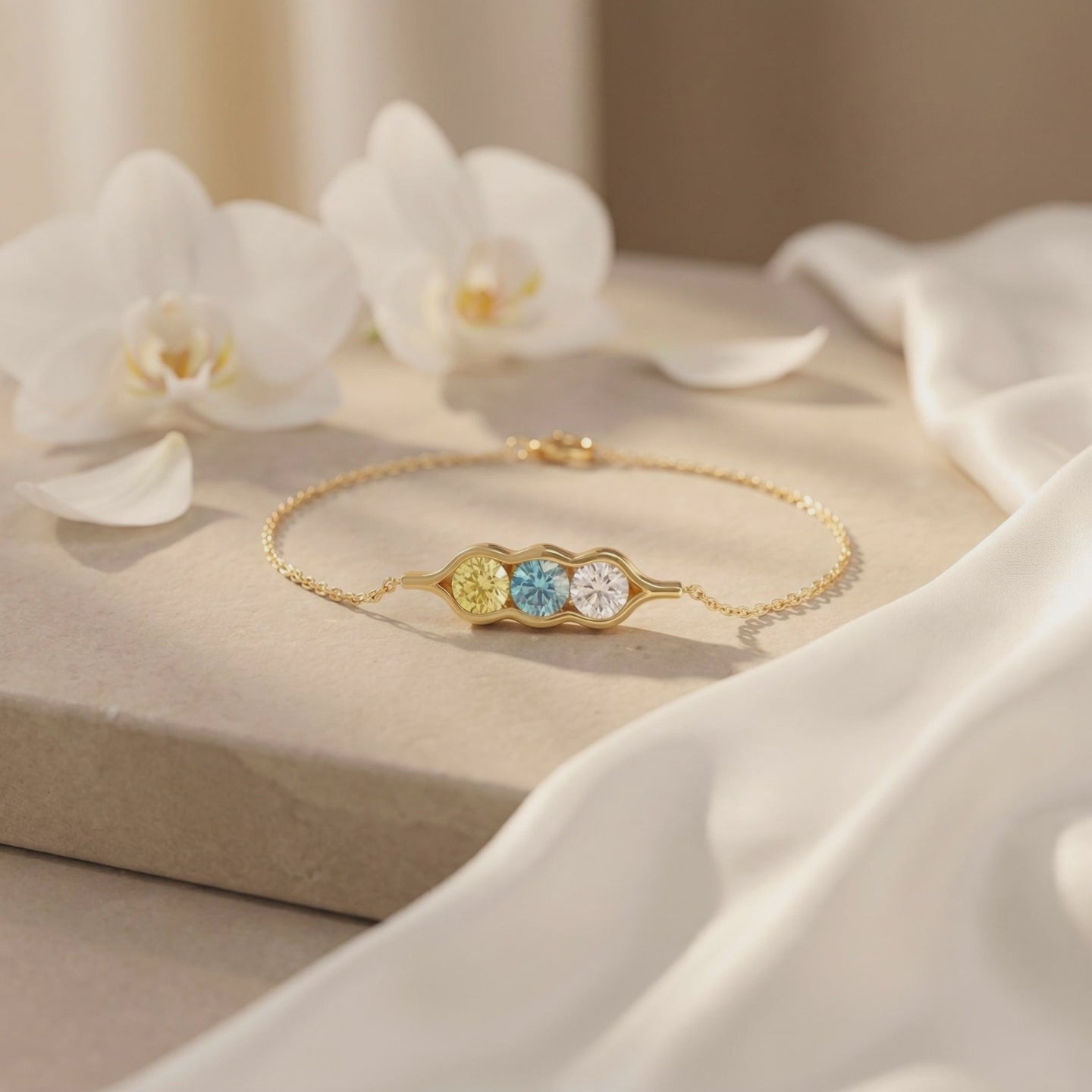 The Adelaide solid gold bracelet with a three-peas-in-a-pod bezel setting.