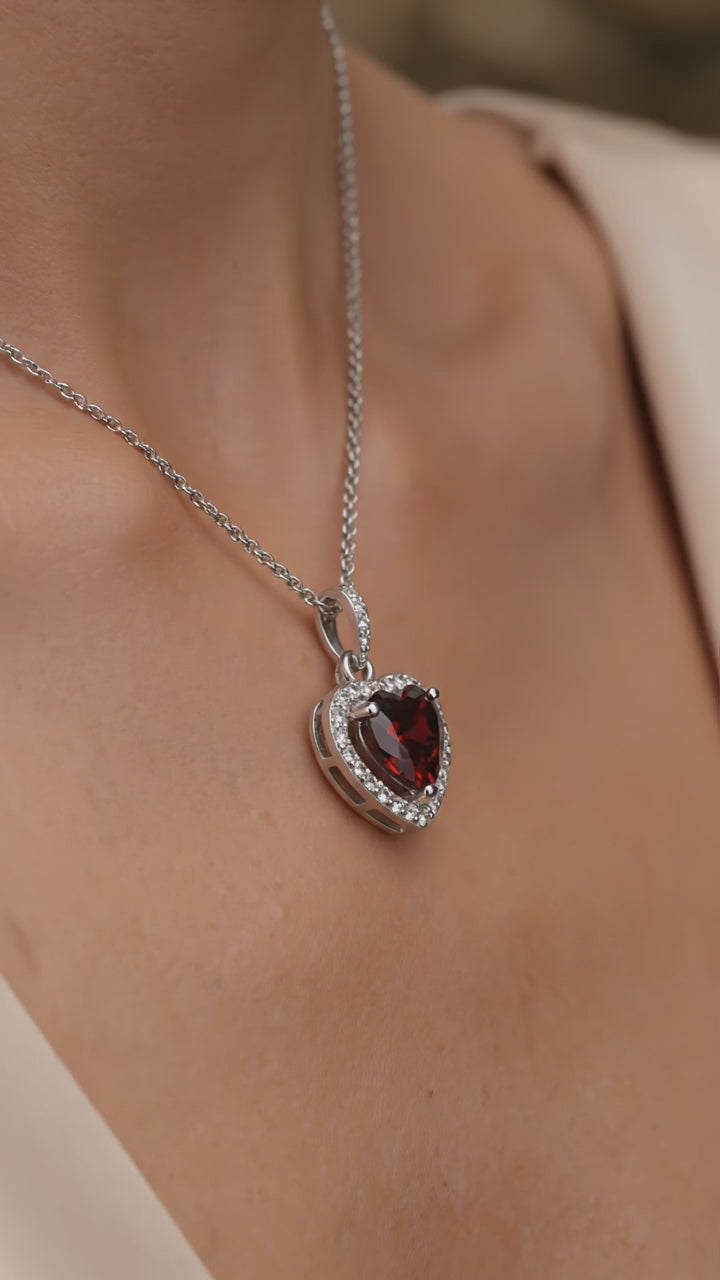 A heart-cut simulated garnet solid gold necklace.