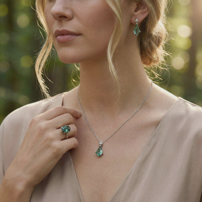 A solid gold jewelry set with green moissanite and moss agate.