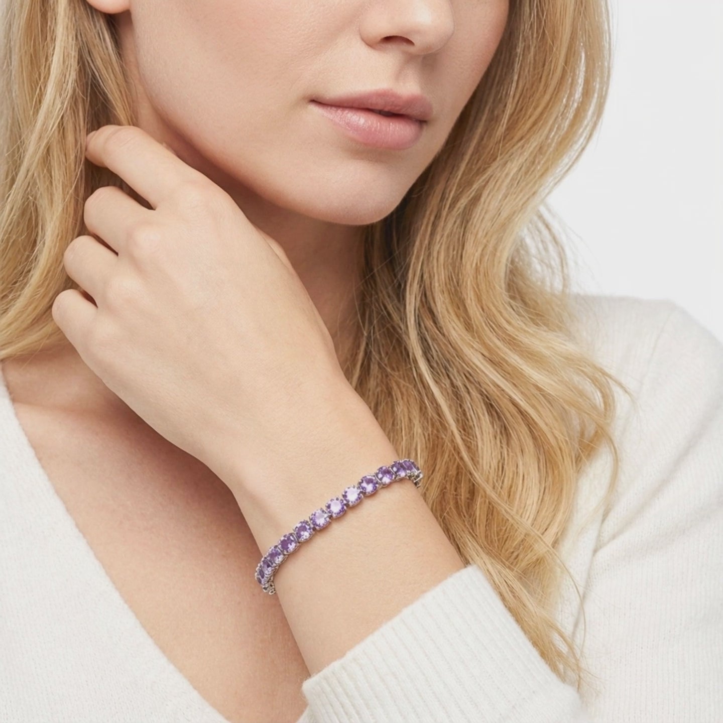 Solid gold tennis bracelet with simulated amethysts.
