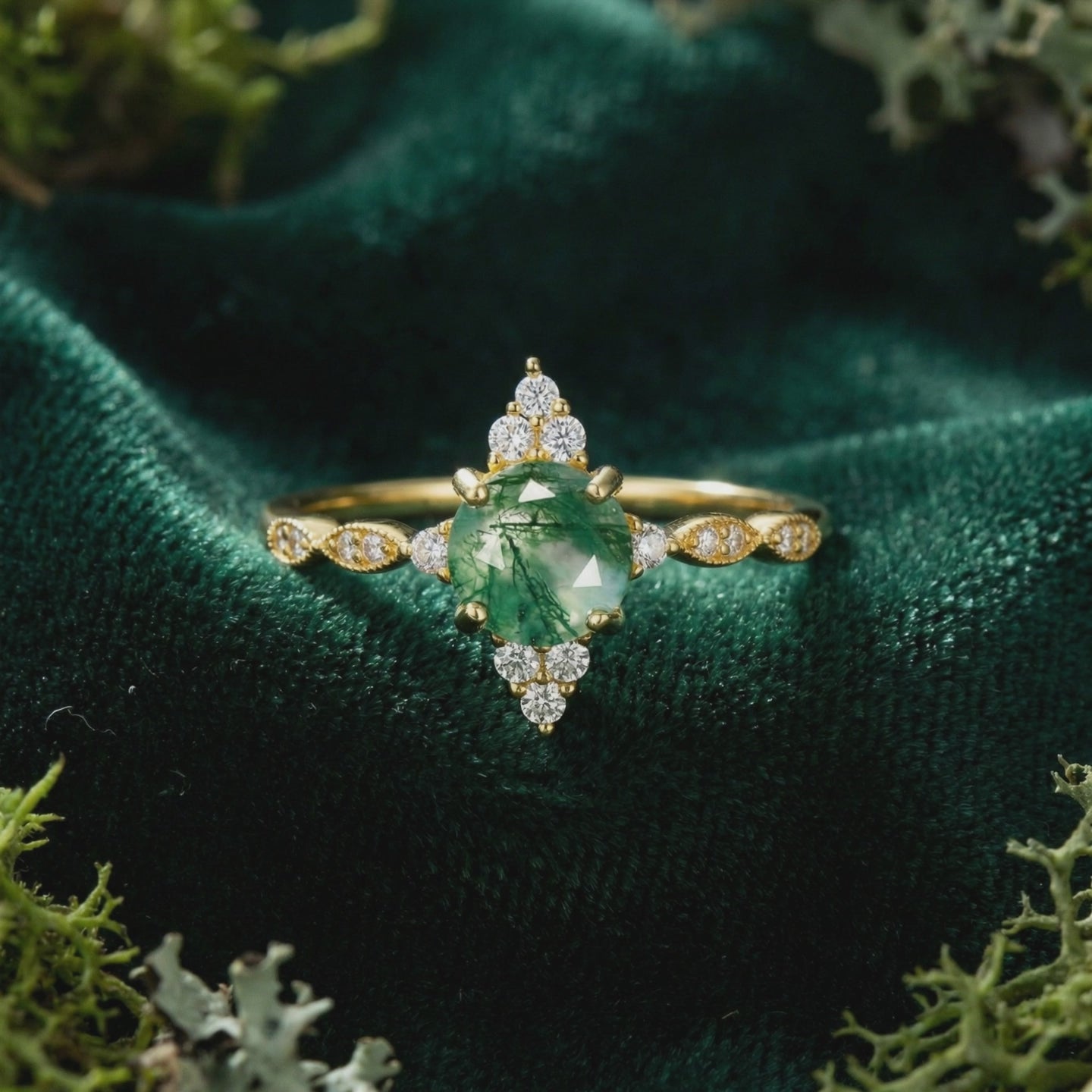 Solid gold ring with a marquise natural moss agate stone in a sunburst setting.