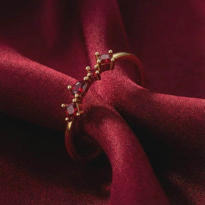 The Julianna cluster ring in solid gold with simulated rubies.