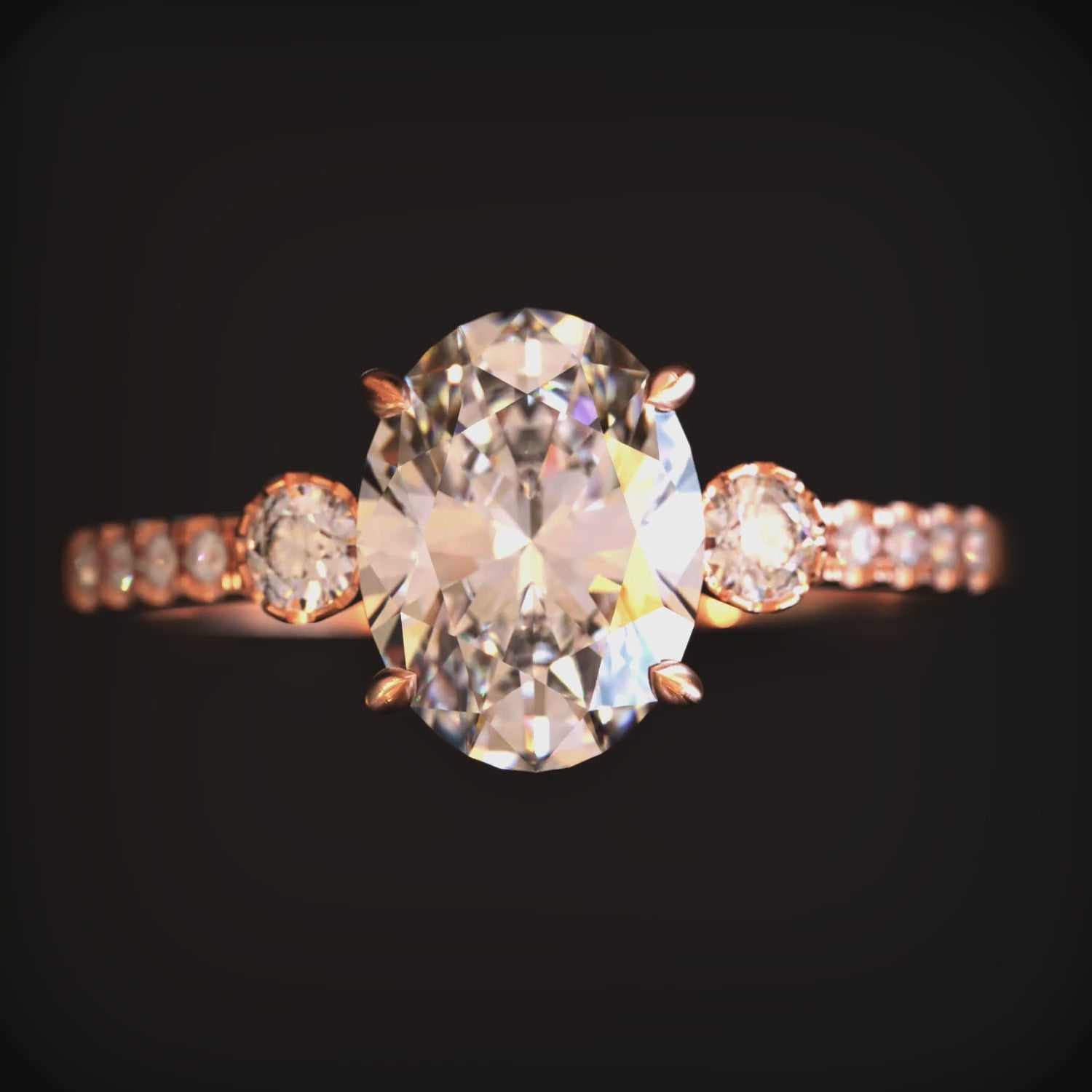 Video of The Luna solid gold ring with an oval moissanite stone and simulated diamond eternity band.