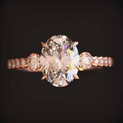 Video of The Luna solid gold ring with an oval moissanite stone and simulated diamond eternity band.