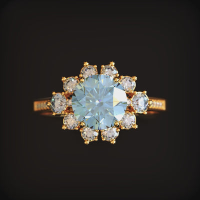 A ring with a blue moissanite center stone and halo in solid gold.