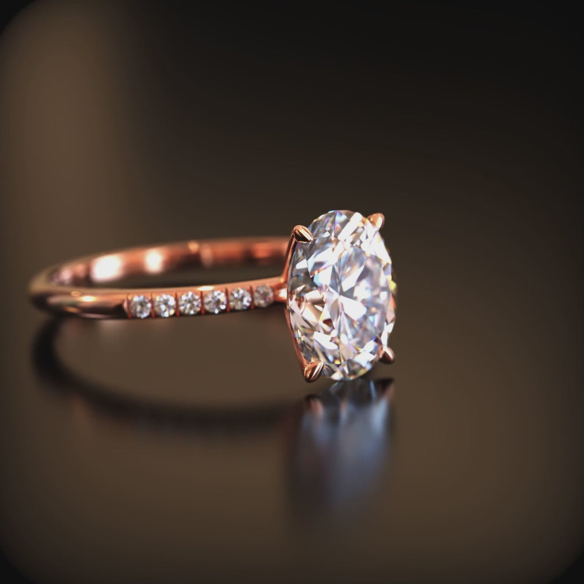 A solid gold engagement ring with an oval moissanite stone.
