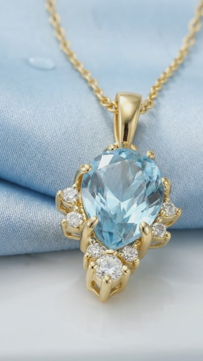 Simulated aquamarine solid gold necklace.