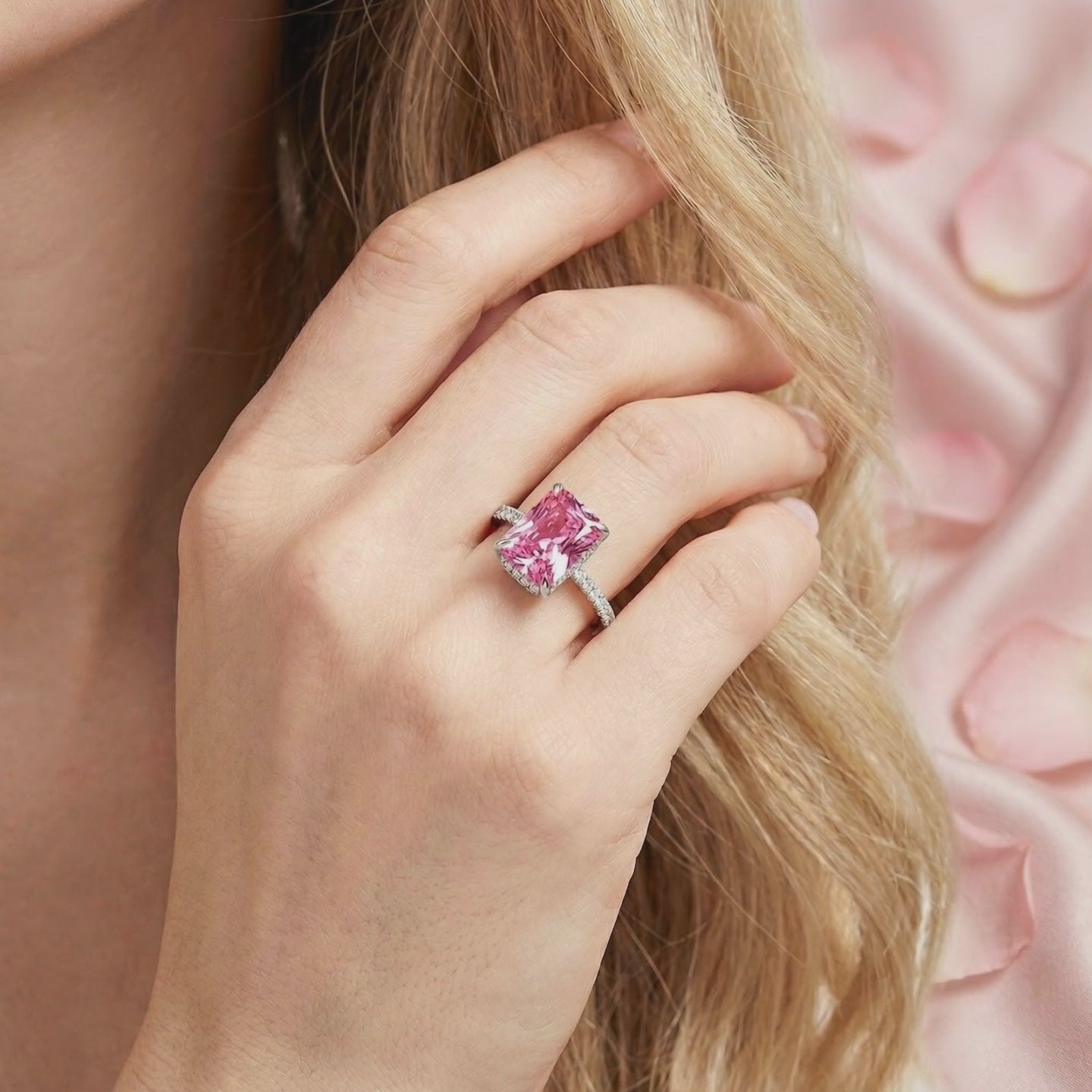 Radiant cut simulated pink tourmaline solid gold ring worn on a hand.