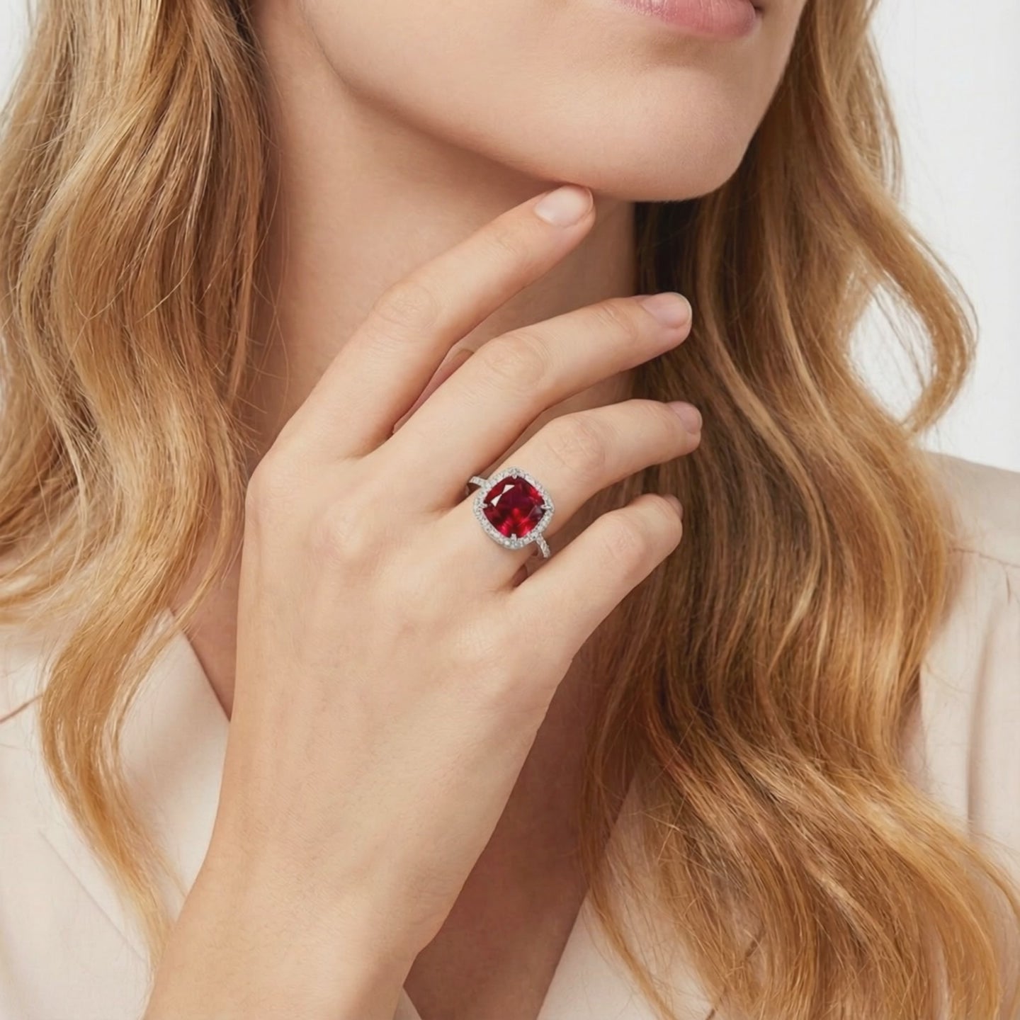 Cushion-cut simulated ruby halo ring in solid white gold.