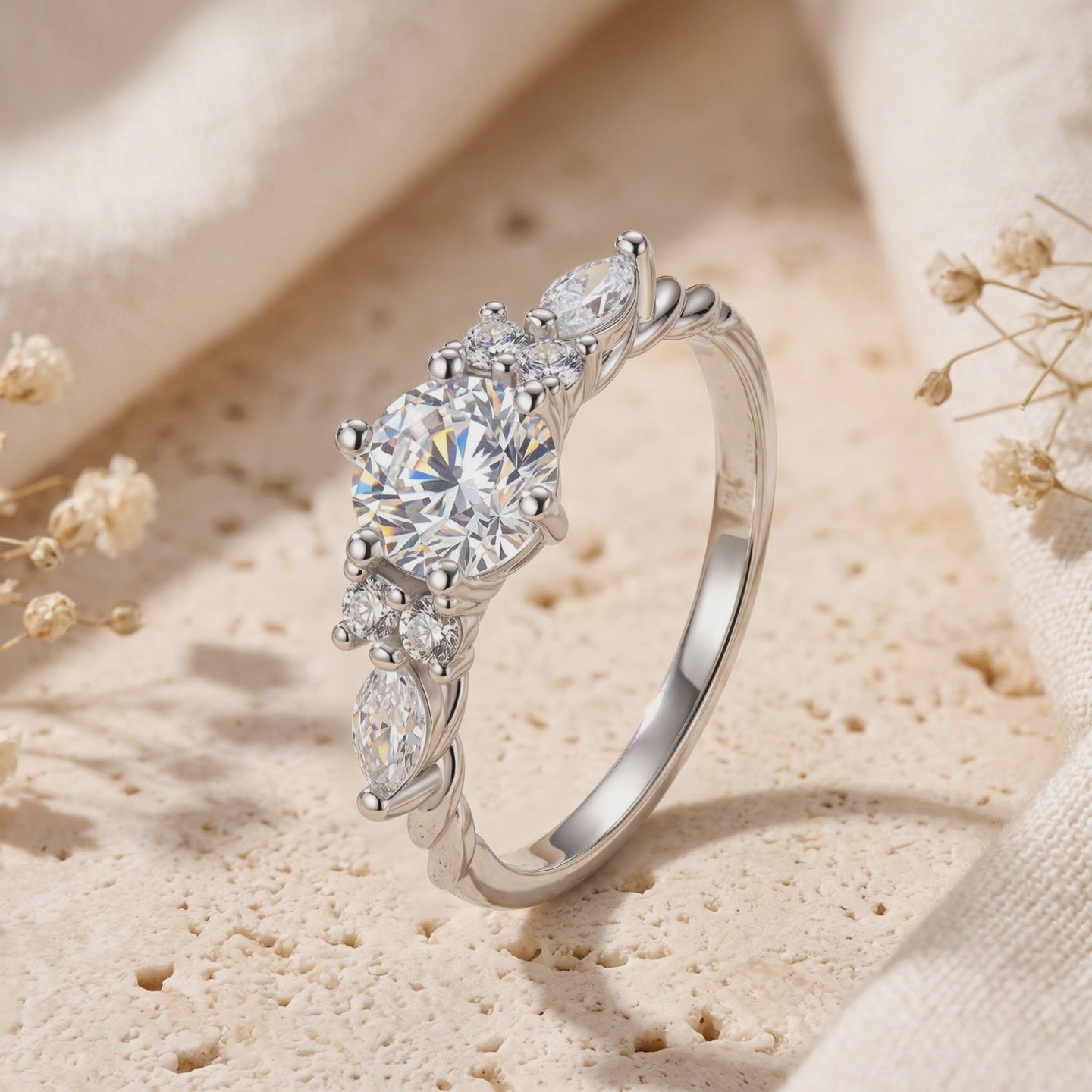 Close-up of The Carlotta solid gold ring with simulated diamonds on a textured surface.