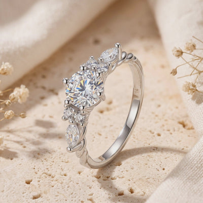 Close-up of The Carlotta solid gold ring with simulated diamonds on a textured surface.