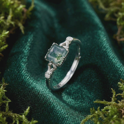A solid gold ring with a natural moss agate gemstone.