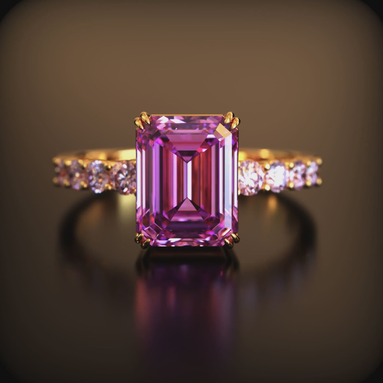 Video preview of the 1CT emerald-cut pink moissanite ring in solid gold on a dark reflective background.