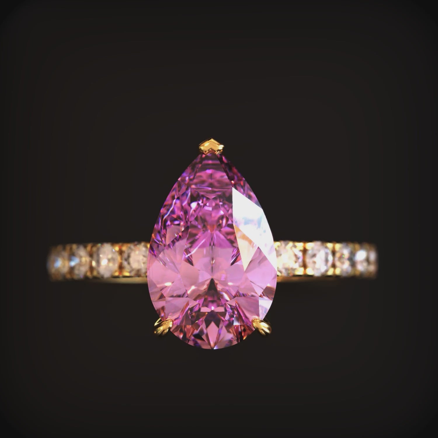 The Celina solid gold ring featuring a 3 carat pear-cut pink moissanite.