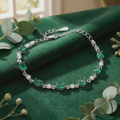 Solid gold bracelet with simulated emeralds.