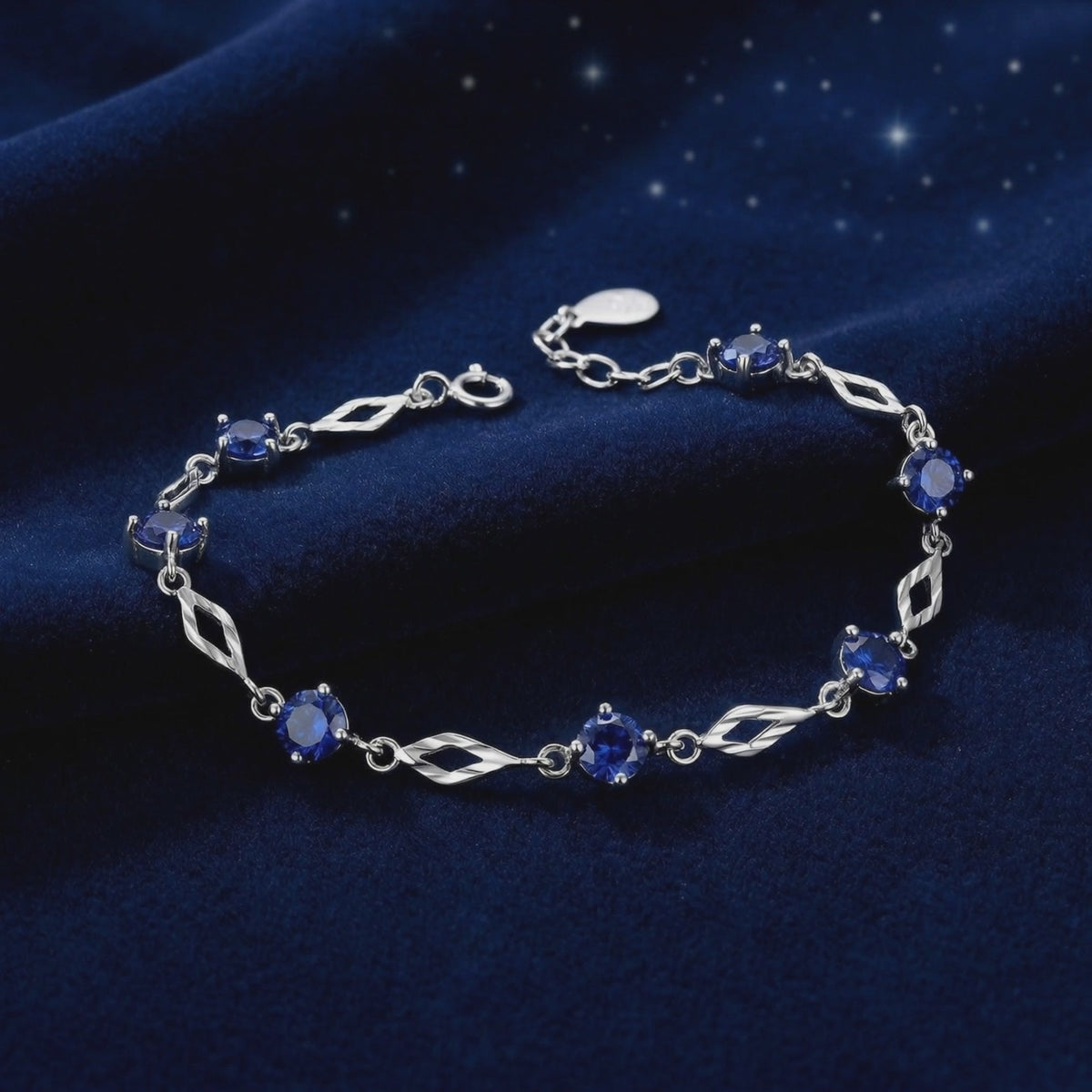 Solid gold station bracelet with simulated sapphires.