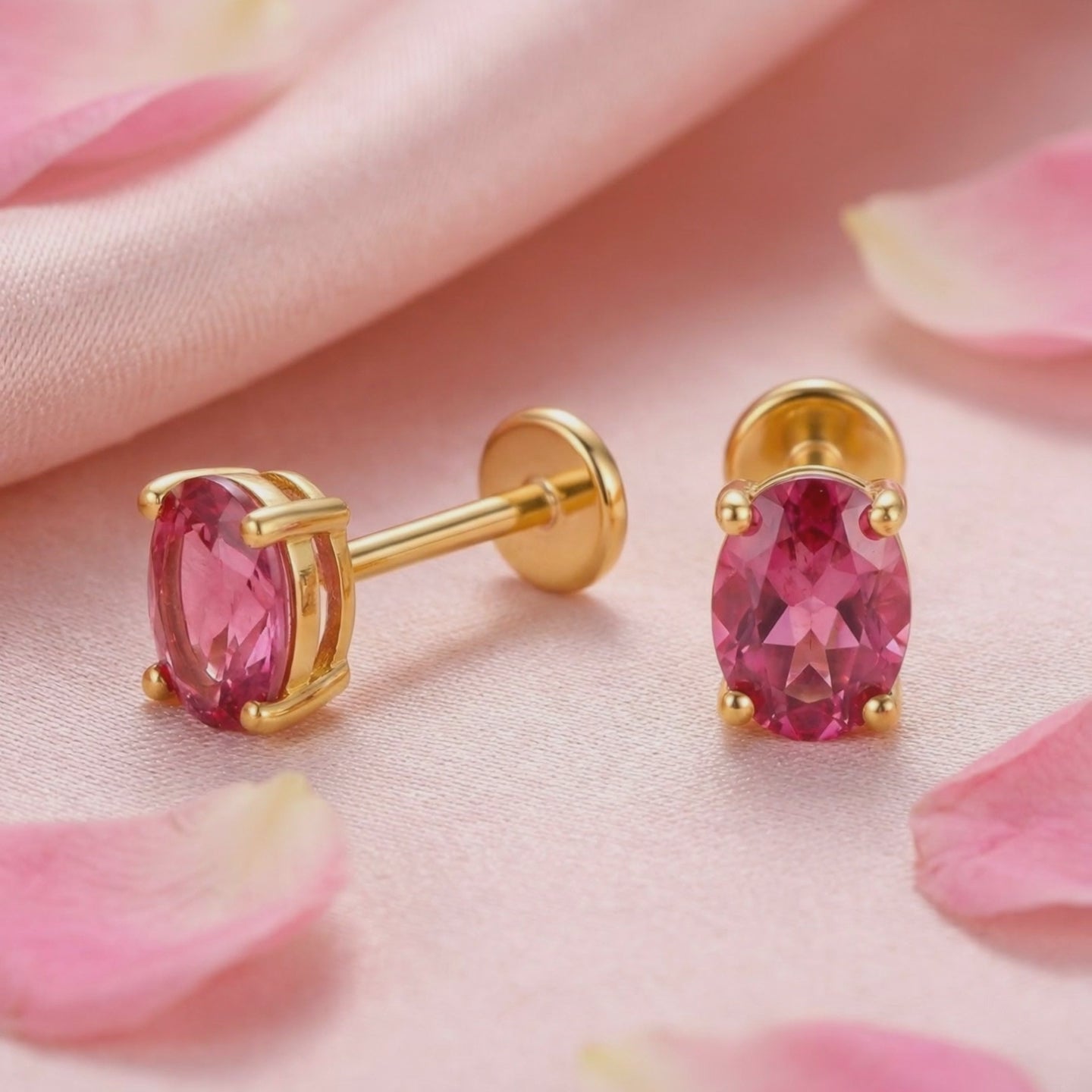 Precision oval cut simulated pink tourmaline stud earrings crafted in solid gold.