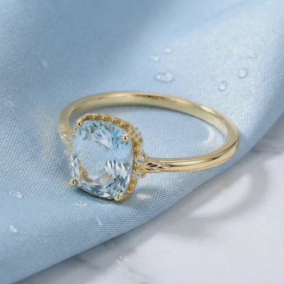 Solid gold ring with simulated aquamarine stone.