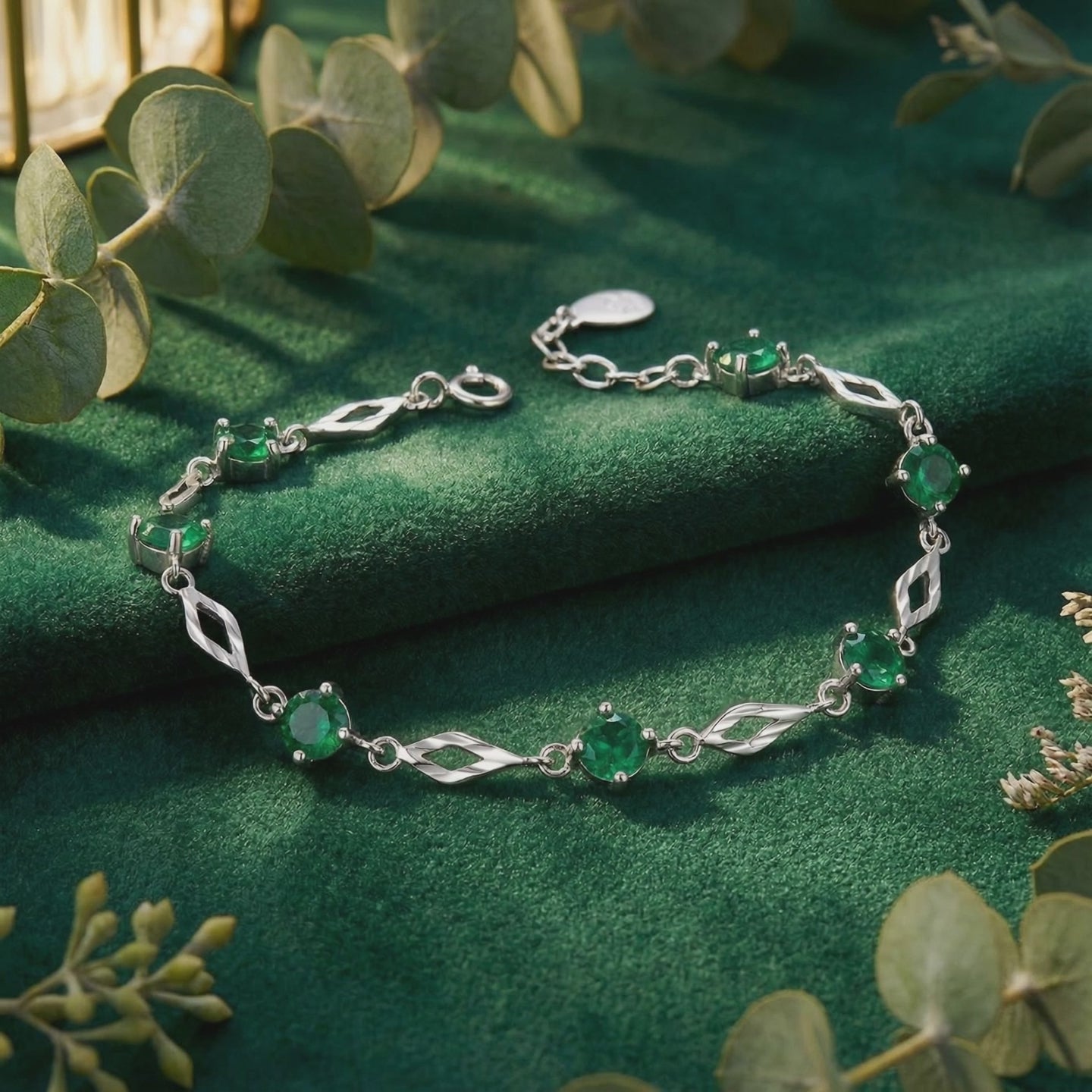 Solid gold bracelet with simulated emeralds.