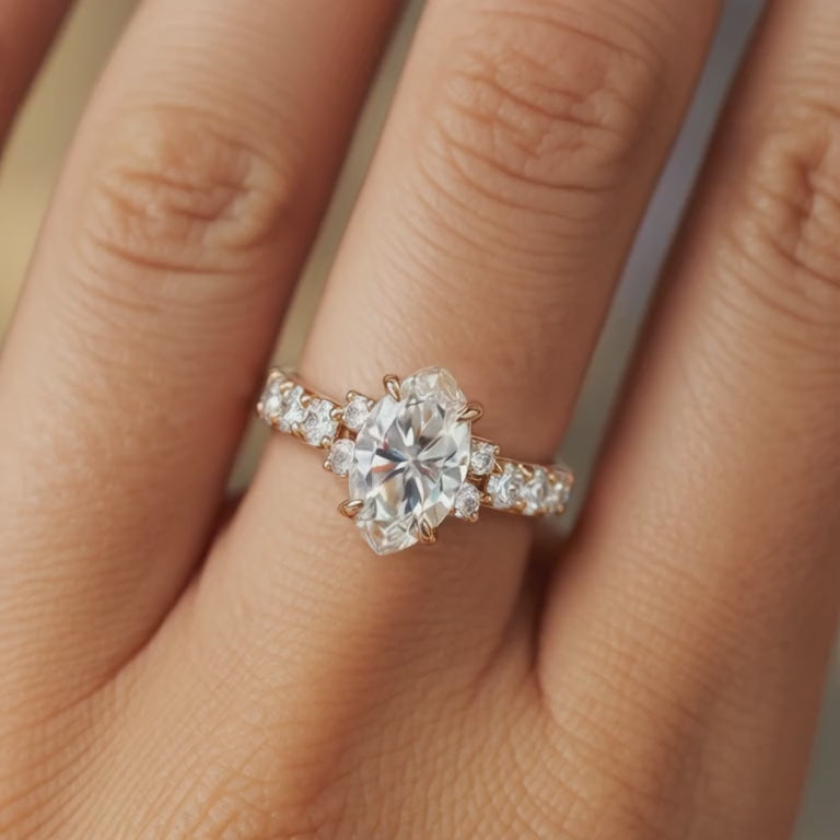 A solid gold ring with a marquise-cut moissanite center stone.