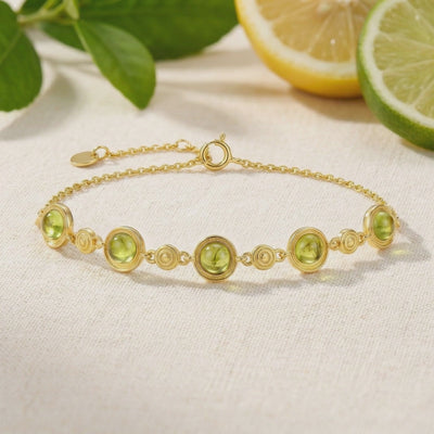 Solid gold simulated peridot station bracelet.