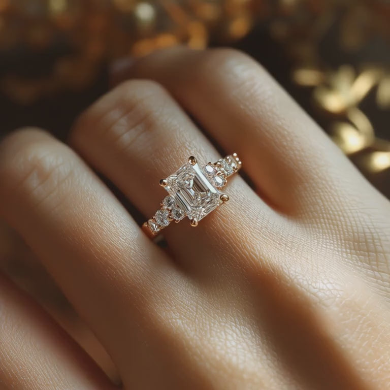 A solid gold ring featuring a 5 carat emerald cut moissanite center stone