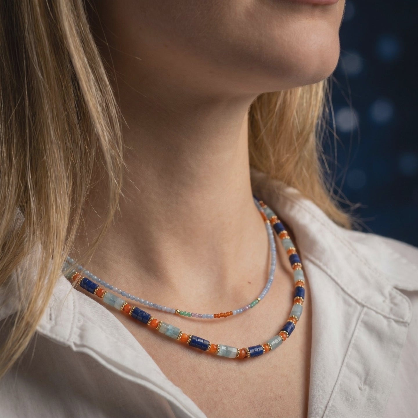 Layered solid gold necklace with natural lapis lazuli beads.
