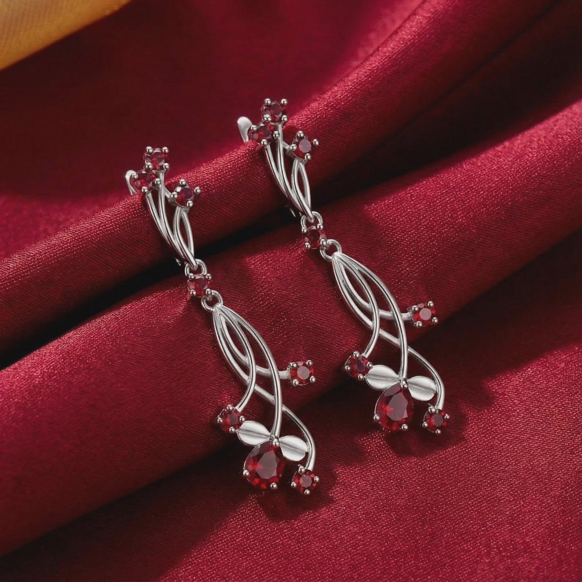 Valisara solid gold drop earrings with simulated rubies.