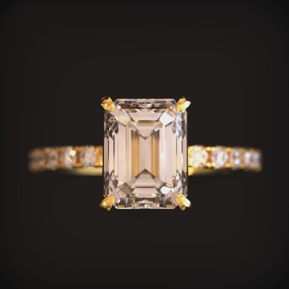 A solid gold ring with a 2CT emerald-cut moissanite gemstone.