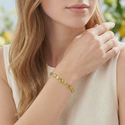 Solid gold simulated peridot station bracelet.