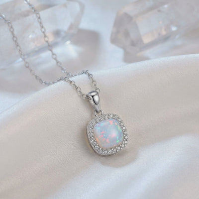 A solid gold cushion opal pendant necklace.