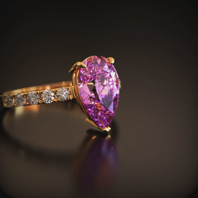The Celina solid gold ring featuring a 3 carat pear-cut pink moissanite.
