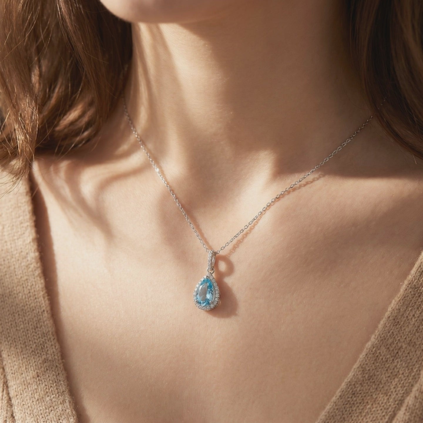 Aquamarine halo pendant necklace in solid gold.