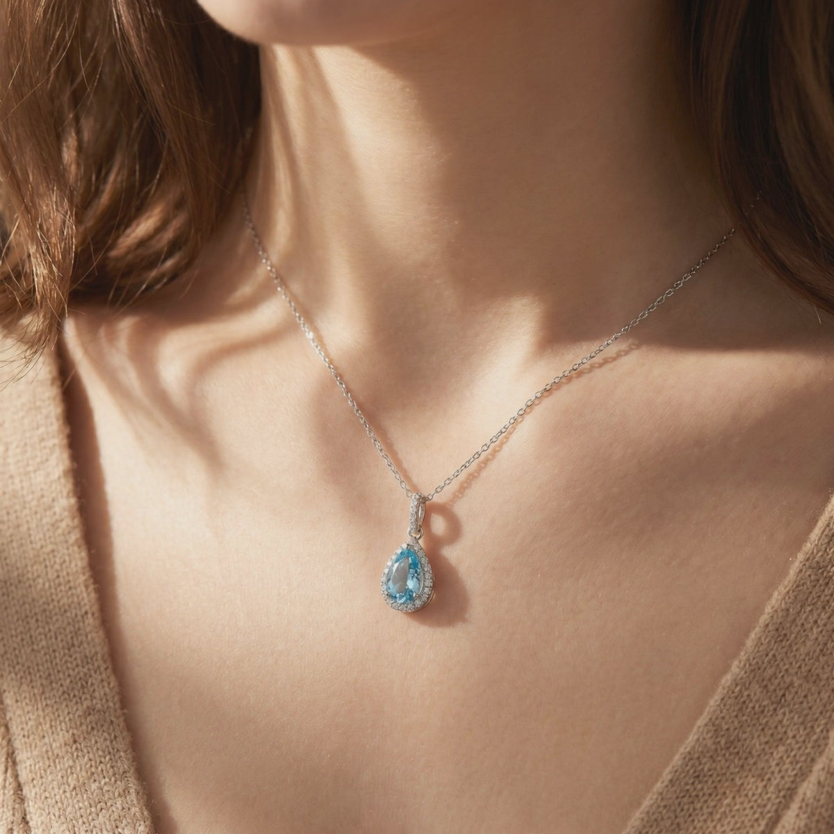 Aquamarine halo pendant necklace in solid gold.