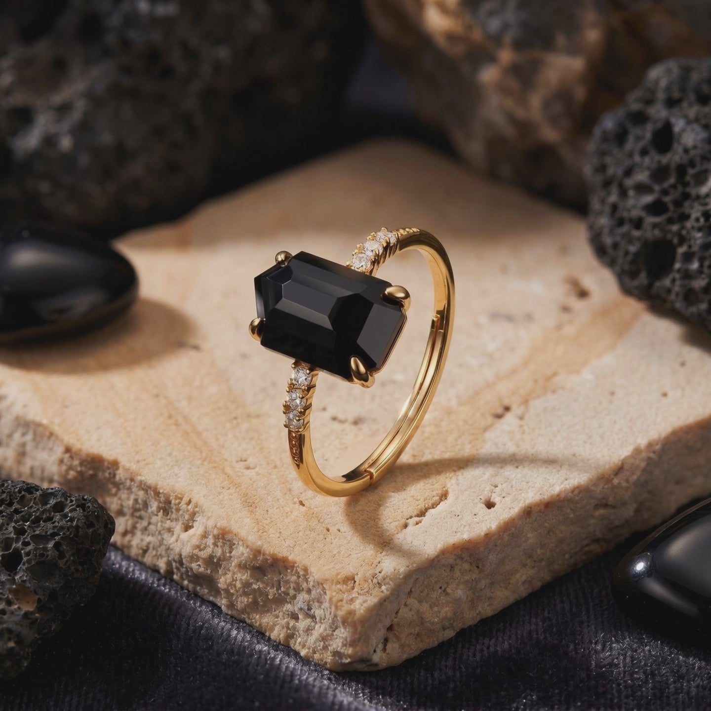 Detailed view of the Noctura solid gold ring with an irregular-cut natural black onyx.