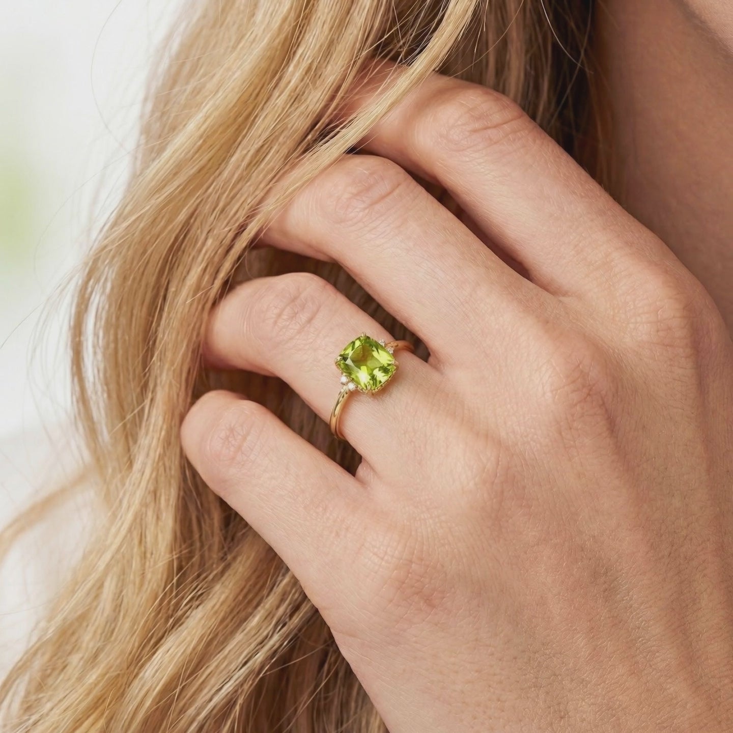 A solid gold ring with a simulated peridot stone.