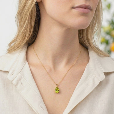 Teardrop simulated peridot pendant necklace in solid gold.