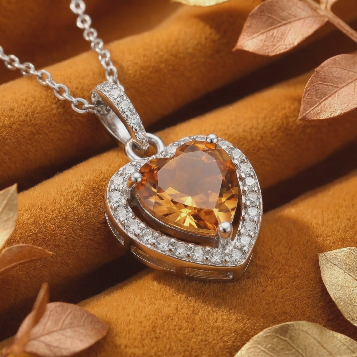 A solid gold necklace with a heart-cut simulated topaz pendant.
