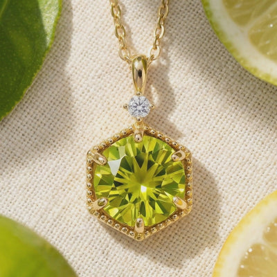 A video showcasing the solid gold necklace with a hexagonal simulated peridot pendant.