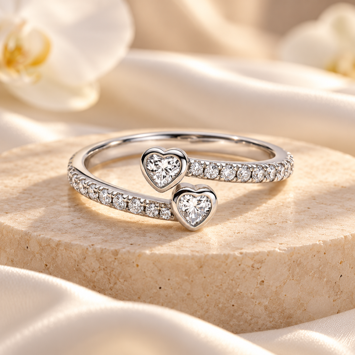 Silver sister ring with two heart-shaped clear stones and pavé band