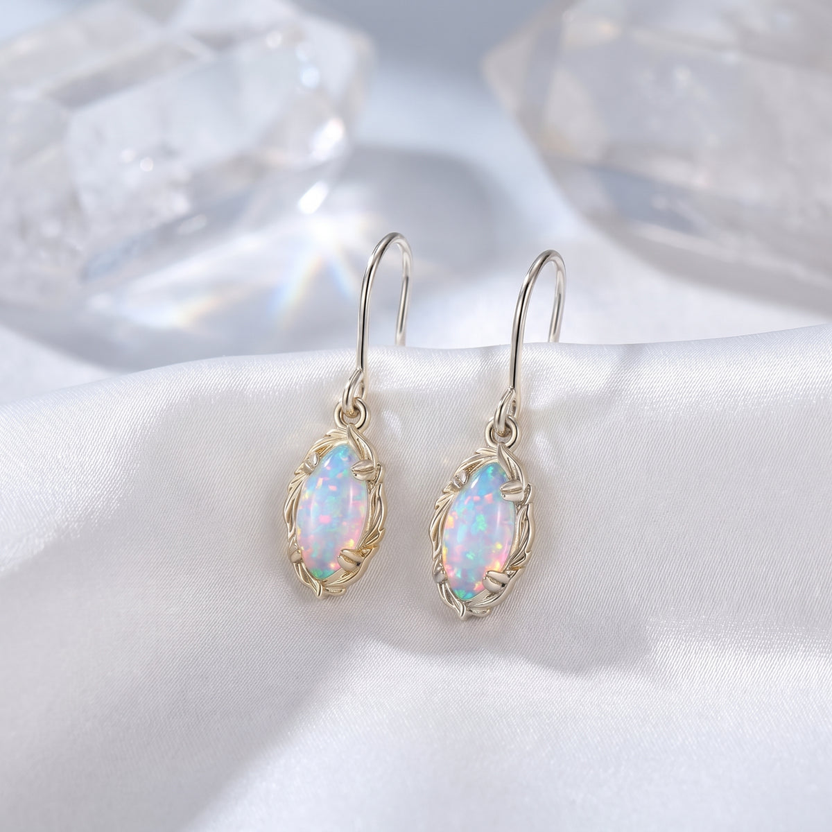 White gold mariquesa-cut white opal drop earrings.